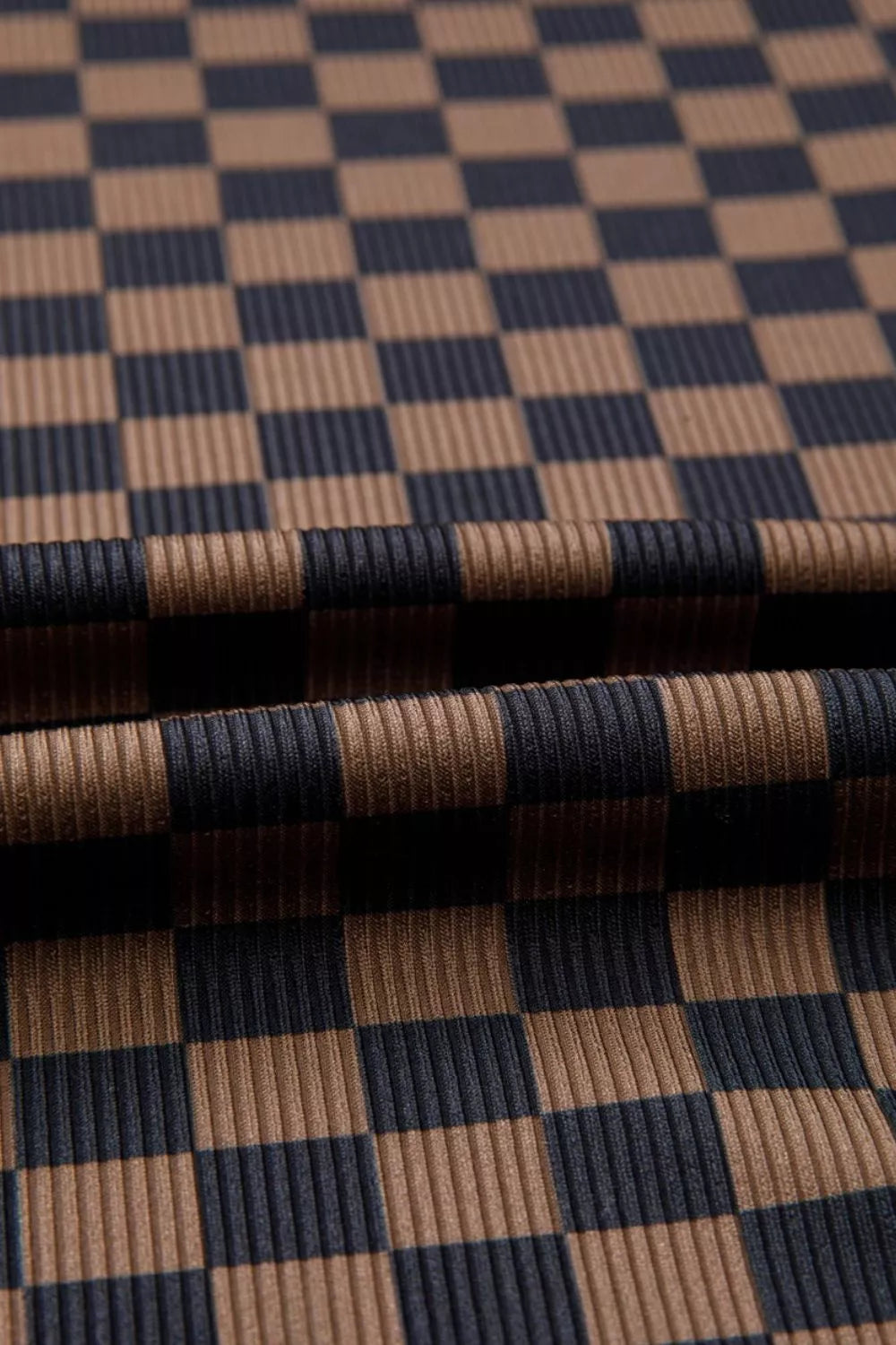 Checkerboard knit t-shirt in dark brown and navy with a ribbed texture.