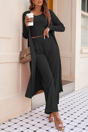 Black ribbed knit duster, crop top, and wide-leg pants lounge set.