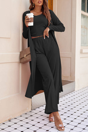 Black ribbed knit duster, crop top, and wide-leg pants lounge set.