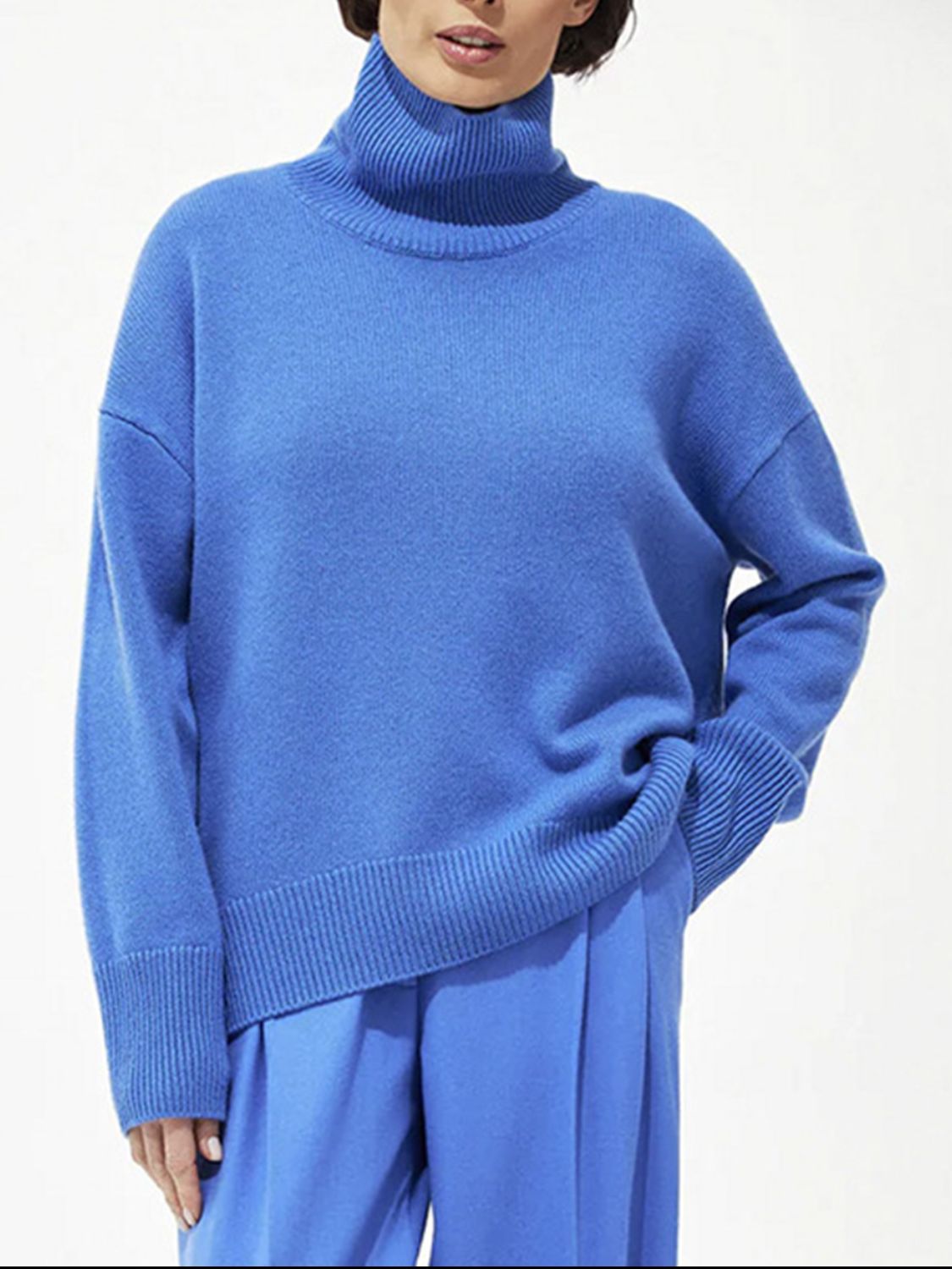Relaxed fit royal blue ribbed turtleneck knit sweater with ribbed cuffs and hem.