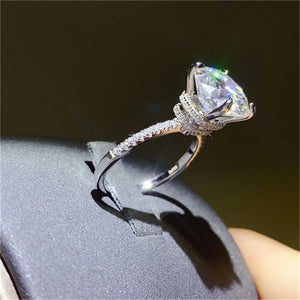 Sterling silver ring with a large solitaire diamond and pave band.
