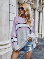 Colorblock slouchy knit tunic in lilac and gray acrylic with a relaxed fit and crew neckline.