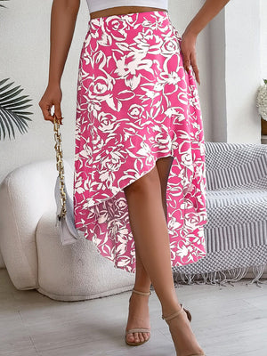 Asymmetric floral print midi skirt in fuchsia pink with a high-low hem.
