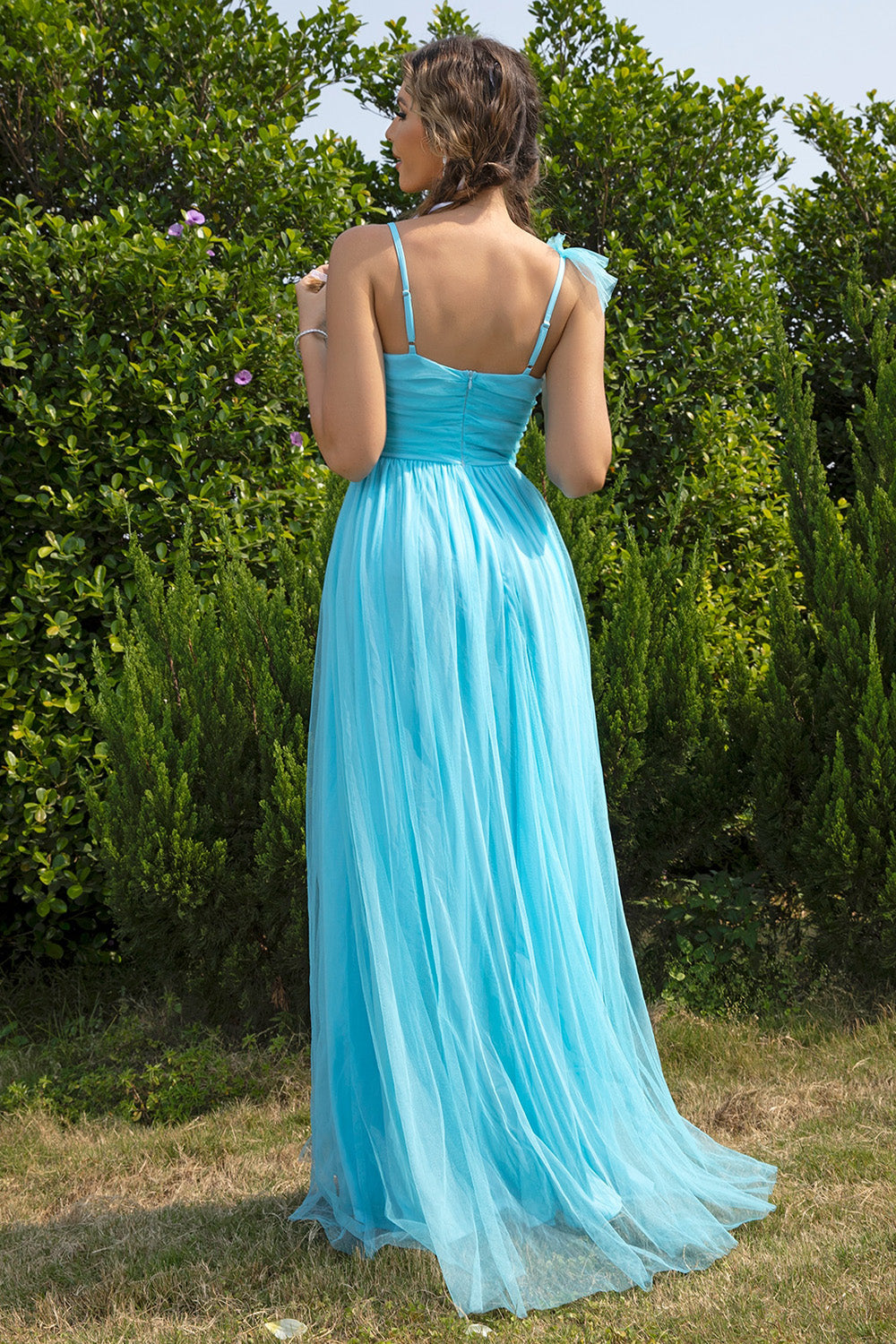 Aqua tulle gown with spaghetti straps, ruched bodice, and flowing skirt.