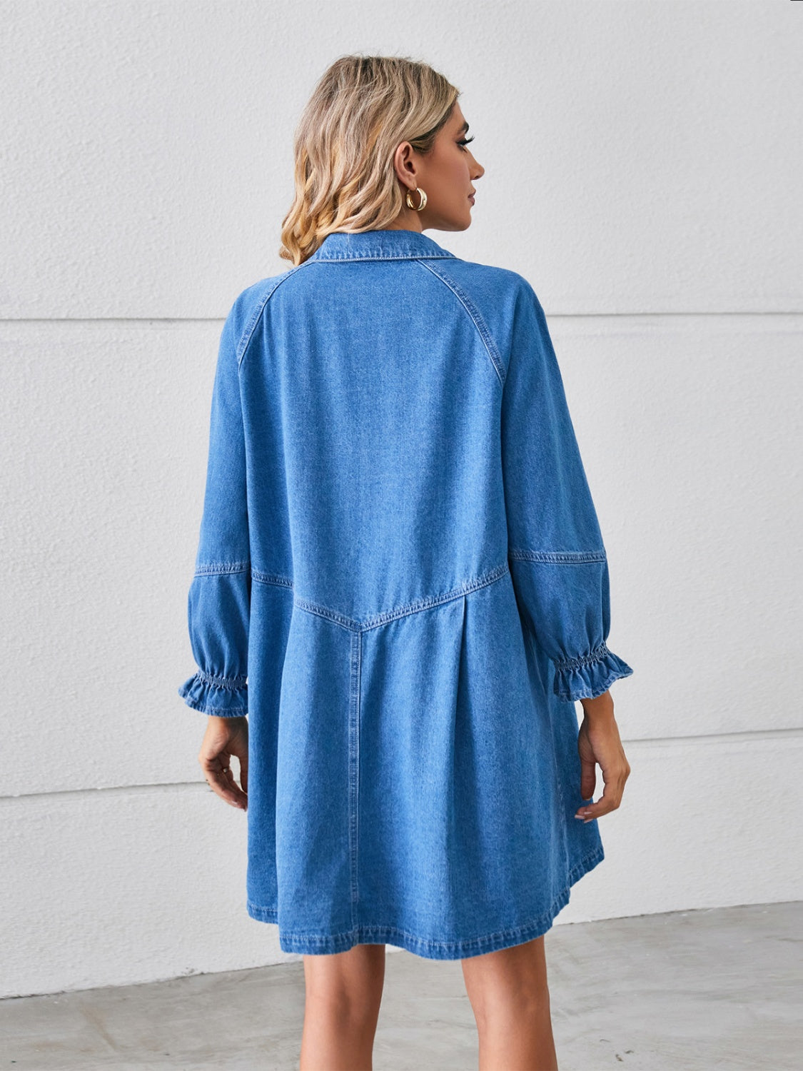 Denim shirtdress in dark blue with ruffled cuff sleeves and a gathered hem.
