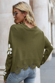 Green acrylic sweater with distressed hem and daisy appliqués on sleeves.