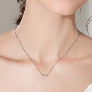 Silver moissanite cluster pendant necklace with D color stones on a delicate chain.