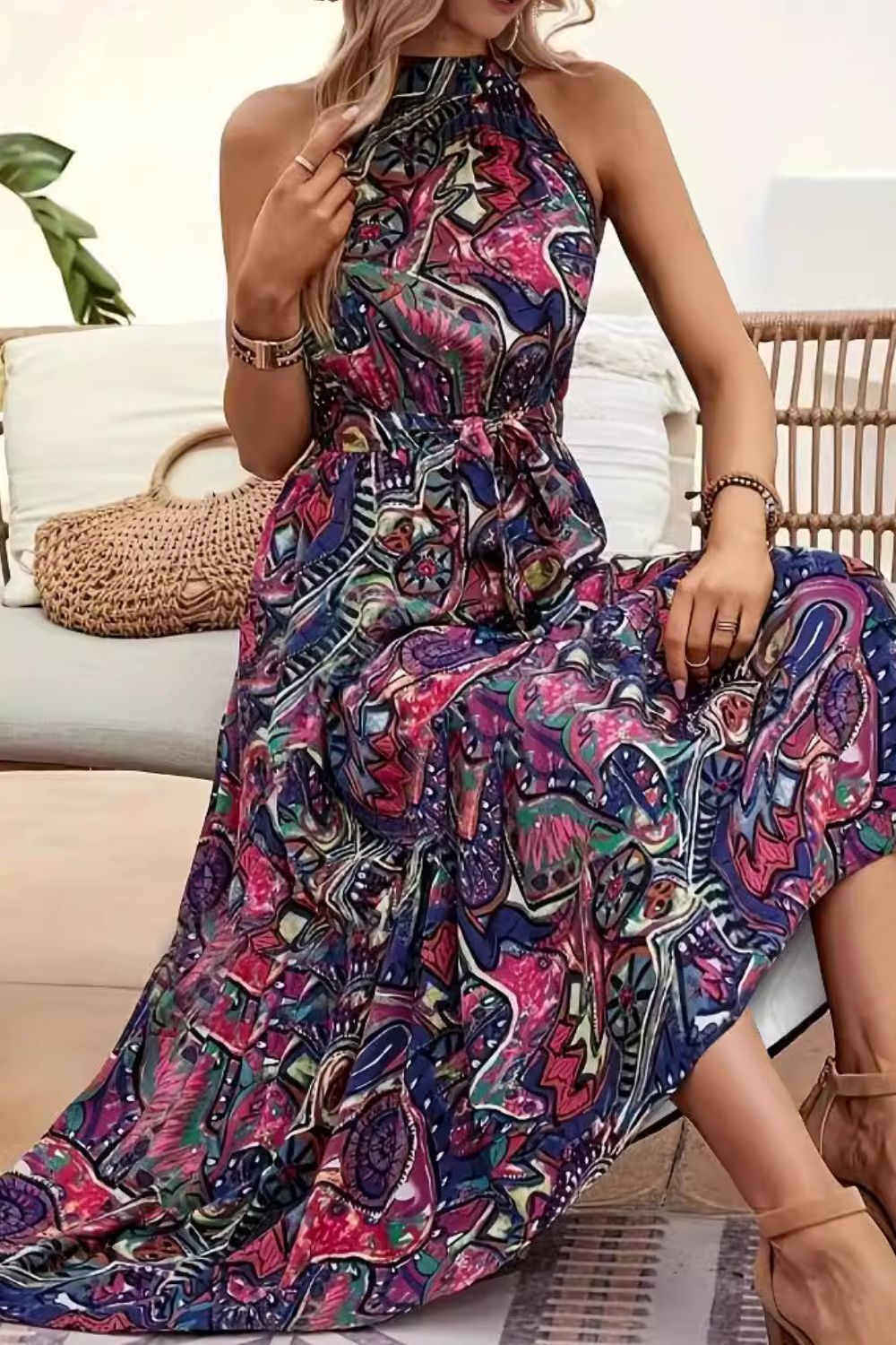 Halter neckline maxi dress with a vibrant paisley print and tie waist.