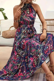 Halter neckline maxi dress with a vibrant paisley print and tie waist.