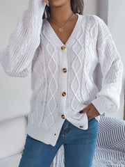 White cable knit cardigan with balloon sleeves and button front.
