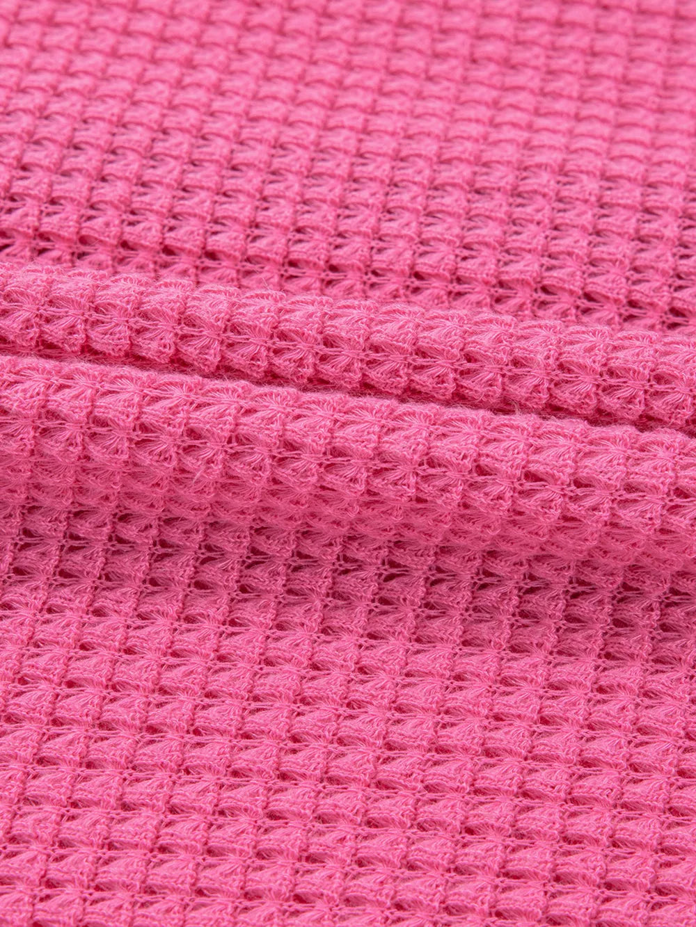Waffle-knit maternity shirt in cerise pink with button detail.