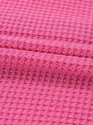 Waffle-knit maternity shirt in cerise pink with button detail.