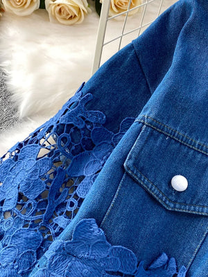 Blue denim two-piece set with lace sleeves and floral embellishments.