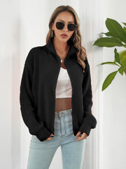 Black ribbed knit zip-up sweater with a mock neck and long sleeves.