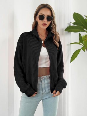 Black ribbed knit zip-up sweater with a mock neck and long sleeves.