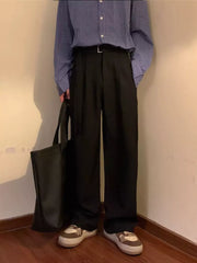 Black wide-leg sweatpants with belted waist and D-ring detail.