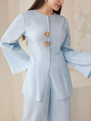 Light blue crinkled texture two-piece set with shell buttons and bell sleeves.