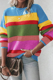 Rainbow stripe knit crewneck sweater with diamond pattern detail and ribbed cuffs.