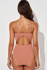 Burnt Coral ribbed one-piece swimsuit with cutout back and adjustable tie sides.