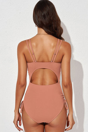 Burnt Coral ribbed one-piece swimsuit with cutout back and adjustable tie sides.