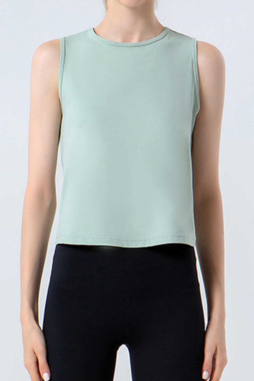 Light green sleeveless performance tank top with crew neck.
