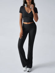 Black ruched waistband flared lounge pants and a matching short-sleeve wrap top.