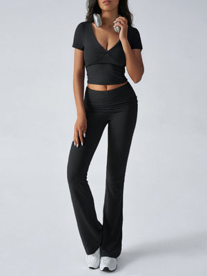 Black ruched waistband flared lounge pants and a matching short-sleeve wrap top.