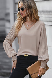Mocha v-neck blouse with pleated long sleeves and elastic cuffs.