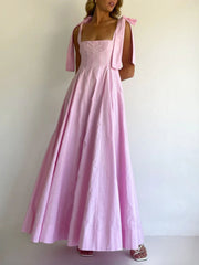 Pink maxi dress with square neckline and bow-tie shoulder straps