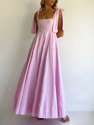 Pink maxi dress with square neckline and bow-tie shoulder straps