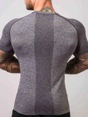 Gray performance raglan tee with textured paneling and breathable fabric.