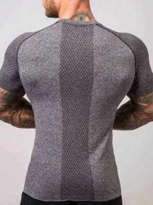Gray performance raglan tee with textured paneling and breathable fabric.