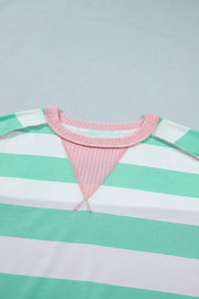 Oversized t-shirt with green and white stripes, pink ribbed neckline and triangular detail.