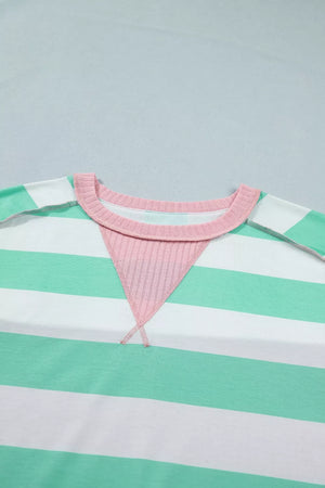 Oversized t-shirt with green and white stripes, pink ribbed neckline and triangular detail.