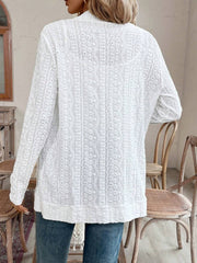 White open-weave embroidered cardigan with long sleeves and a textured pattern.