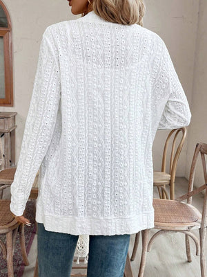 White open-weave embroidered cardigan with long sleeves and a textured pattern.