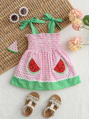 Pink gingham baby dress with smocked bodice, watermelon pockets, and green polka dot trim.