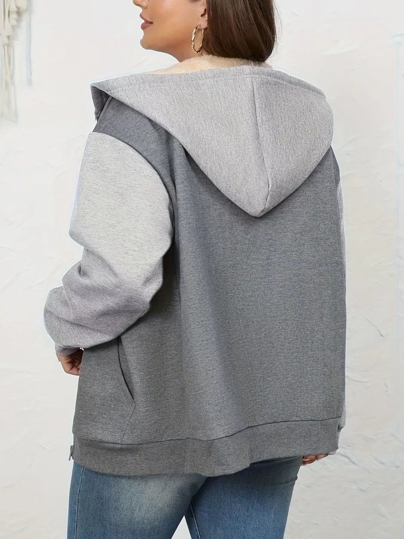 Gray sherpa lined zip-up hoodie with two-tone sleeves and front pocket detail.