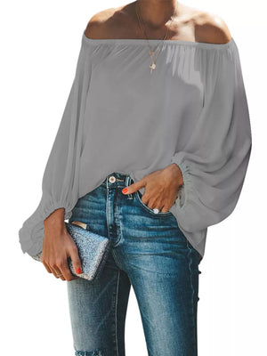 Gray off-shoulder blouse with balloon sleeves and elastic cuffs, styled with jeans.