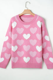 Pink heart intarsia knit sweater with pearl embellishments and crew neck.