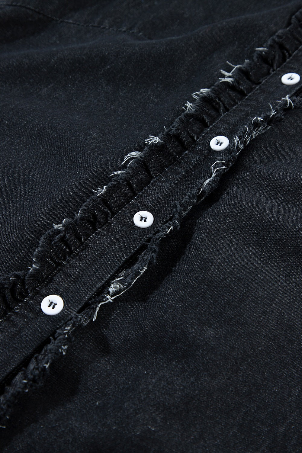 Black denim button-up shirt with frayed ruffle trim and white buttons.