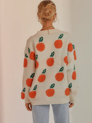 Cream acrylic sweater with orange fruit pattern and green leaves, crew neck, long sleeves.