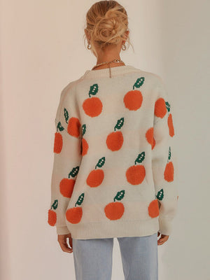 Cream acrylic sweater with orange fruit pattern and green leaves, crew neck, long sleeves.