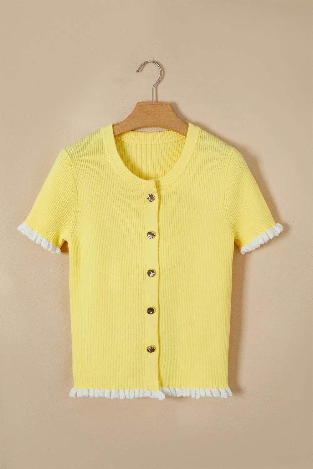 Yellow ribbed knit short sleeve cardigan with frilled trim and gold button details.