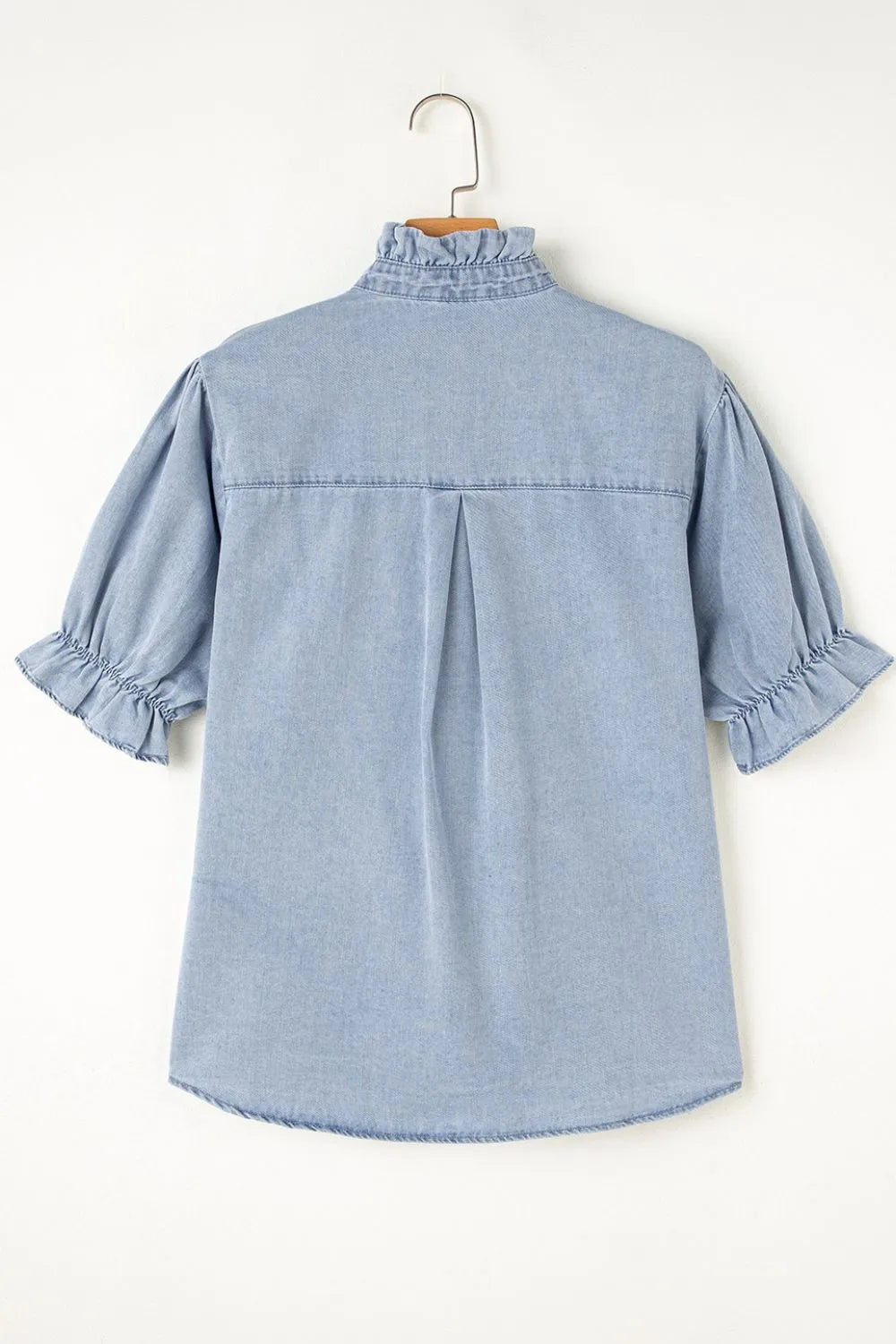 Light blue denim blouse with ruffled collar, puff sleeves, and button front.