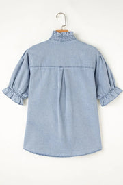 Light blue denim blouse with ruffled collar, puff sleeves, and button front.