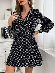 Black polka dot mini dress with V-neck, balloon sleeves, and ruffled hem.