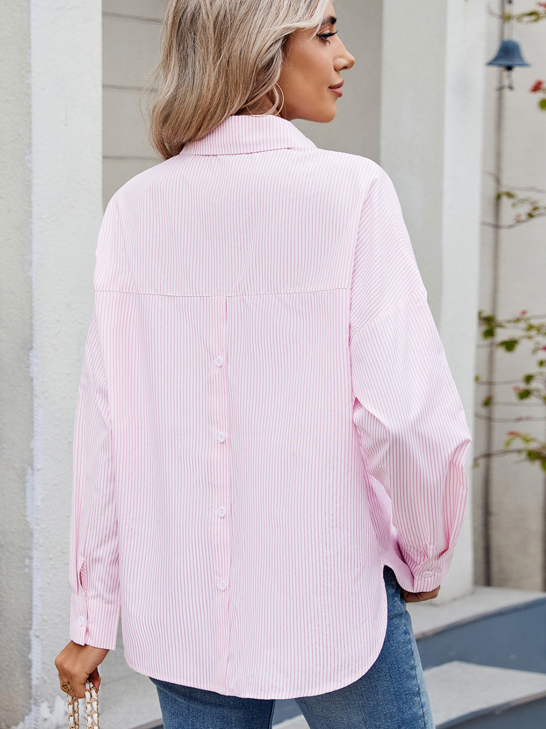 Relaxed fit blush pink pinstripe button-down shirt with back button detail.