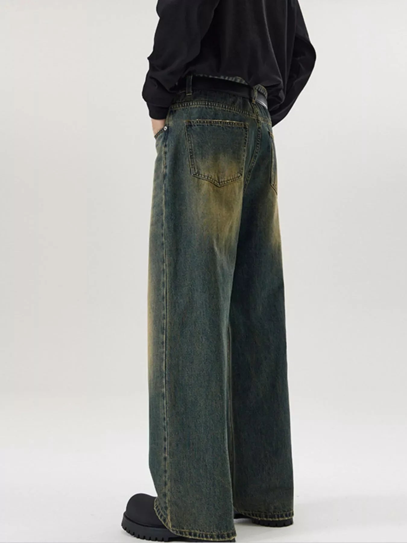 Men's wide-leg jeans in dark blue wash denim with distressed details.