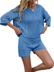 Blue cable-knit two-piece sweater set with crew neck and drawstring shorts.